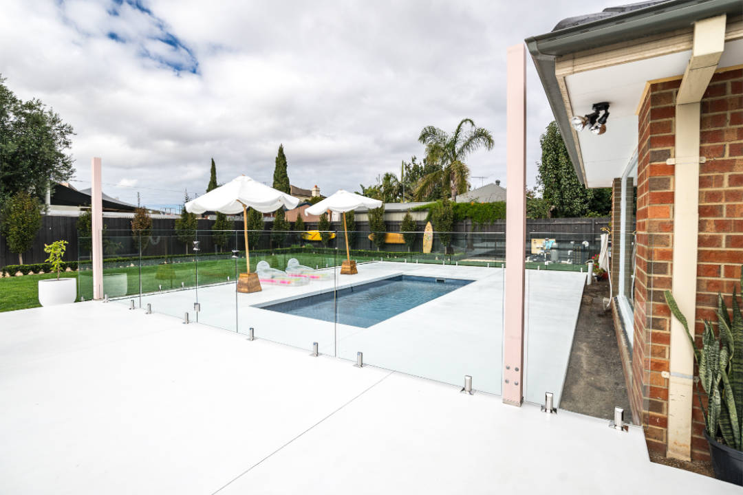 Kerry Custom Works_glass pool fencing_umbrellas_floaties_green grass Acacia Landscaping and Design